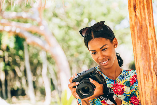 istock Young Black woman with retro digital camera 1180070364