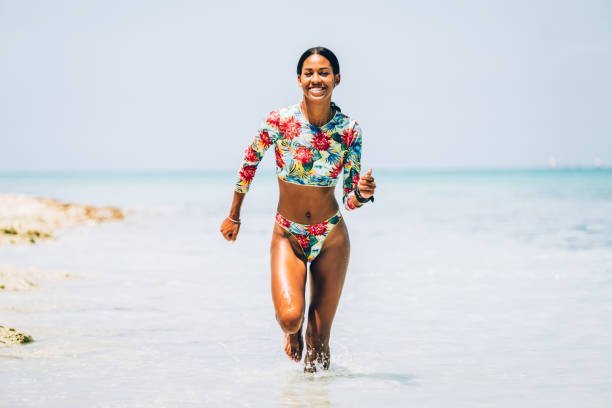 istock Young Black woman at tropical beach 1180070917