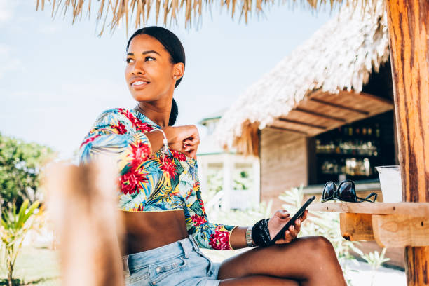 young black woman at resort cabana - summer people tourist slim imagens e fotografias de stock