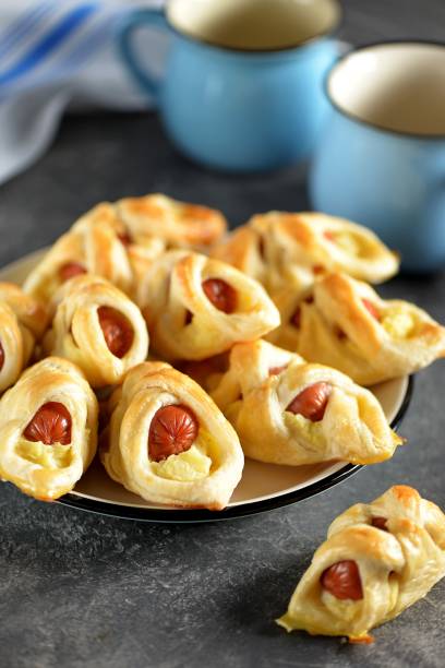 istock Sausages in puff pastry with mashed potatoes on a dark background. 1180072662