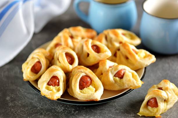 istock Sausages in puff pastry with mashed potatoes on a dark background. 1180072687