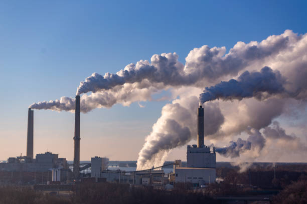 wind blowing pollution - environmental damage power station factory smoke stack imagens e fotografias de stock