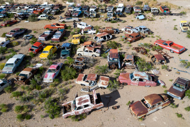 Wrecked, rusty, vintage, American classic cars on a junkyard, aerial view, Arizona, USA.