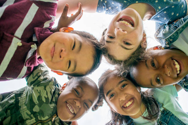 Multi-Ethnic Group of Children Outside stock photo Group of Multi-ethnic school aged children gathering outside together summer camp photos stock pictures, royalty-free photos & images
