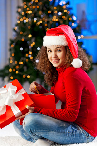 istock Girl opening Christmas present 1180074146