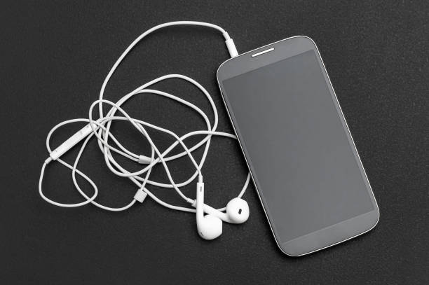 istock Smartphone with headphones on black. Top view. 1180075455