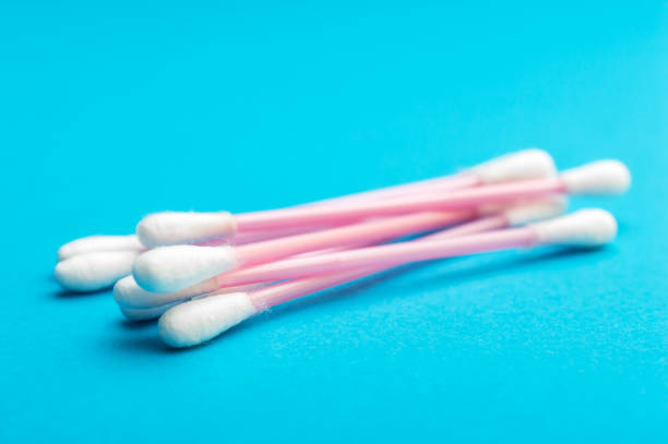 istock Heap of ear sticks on blue background. 1180076137