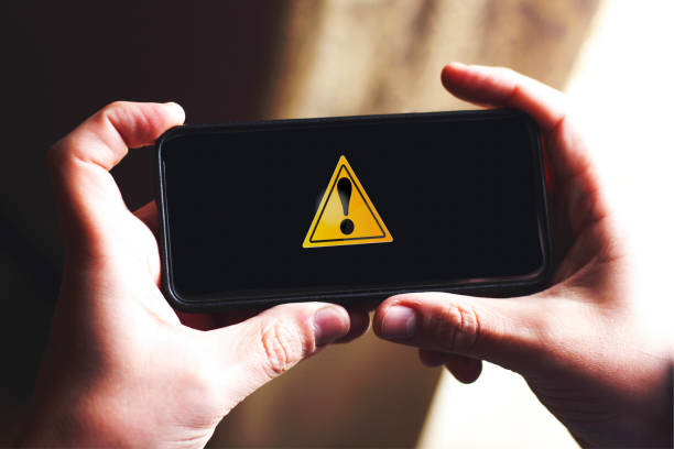 istock alert symbol design on smart phone screen 1180076557