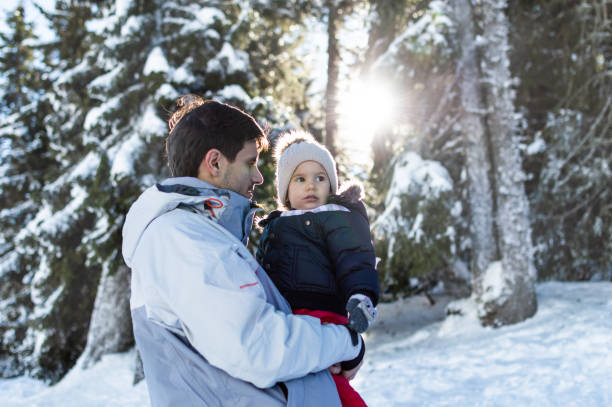 istock Father and daughter on winter snow day 1180077408