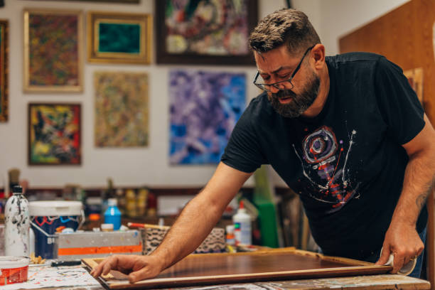istock Man preparing canvas for painting 1180077488