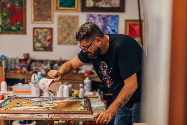 istock Creative male artist painting 1180077761
