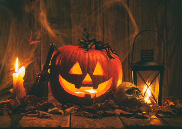 Halloween Jack-o-Lantern Pumpkins on rustic wooden background