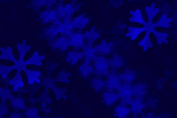 DSLR photo - defocused bokeh with snowflakes shape on a blue background. Space for copy. Can be used as a Christmas background. It's a real bokeh photo, not an illustration or computer filter.
