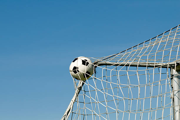 Soccer goal net against blue sky.