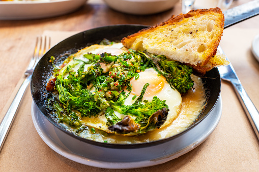 Baked eggs with sweet fennel sausage, broccoli rabe and chiles