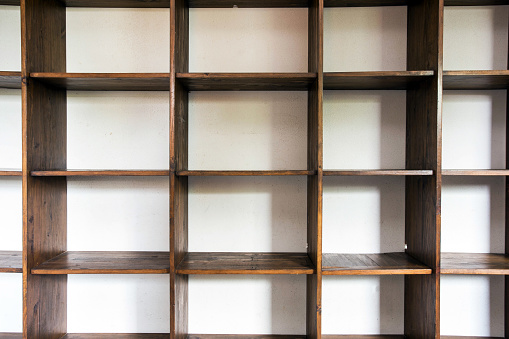 empty wooden cupboard storage near white wall, modern interior closeup