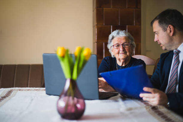 istock Businessman showing documents to old lady 1180086226