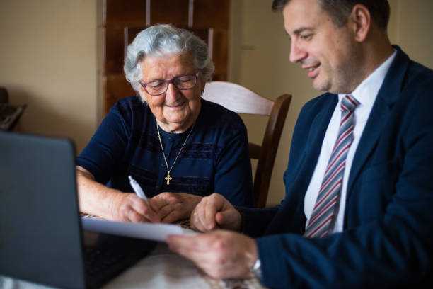 istock Elderly woman signing a contract 1180086330