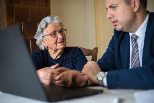 istock Senior woman talking to agent 1180086334
