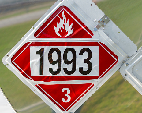 A UN1993 Flammable placard in its holder on a transport trailer.  Required by DOT for transportation of Flammable liquids.