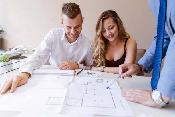 istock Young couple looking for apartment with real estate agent 1180087231