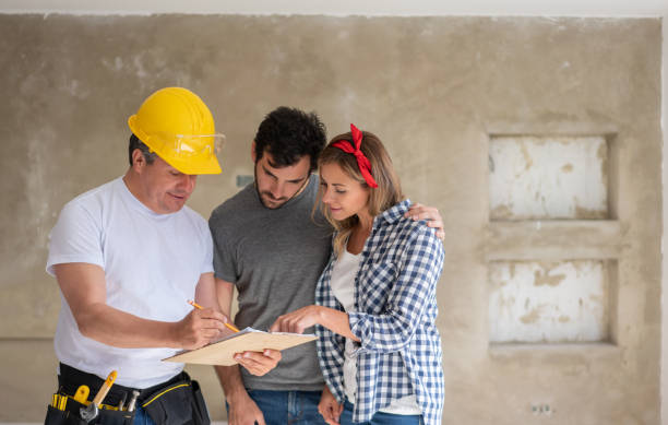 istock Contractor talking to a couple while remodeling their house 1180087350