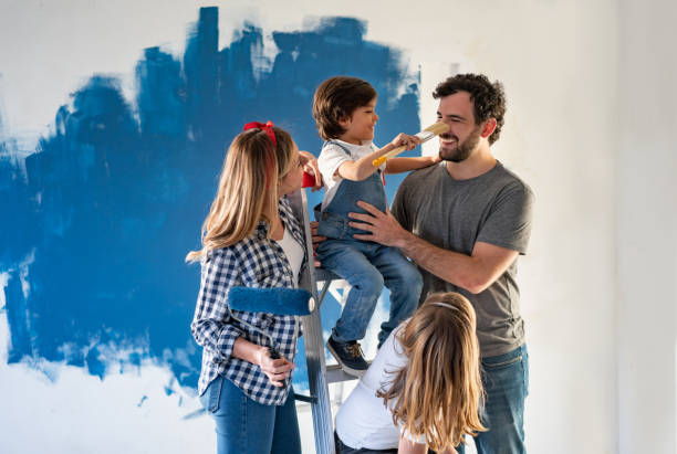 Family having fun while painting their house