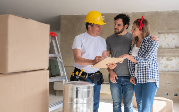 istock Contractor talking to a couple while remodeling their house 1180087477
