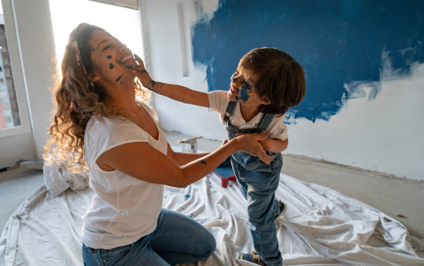 Mother and son painting their house and having fun