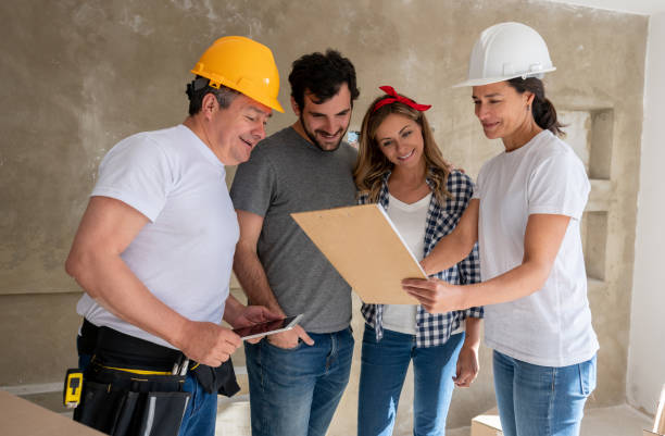 istock Architect and contractor talking to a couple while working on a housing project 1180087514