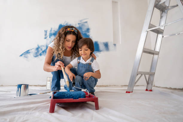 beautiful mother and son painting their house together - home addition home improvement paint decorating imagens e fotografias de stock