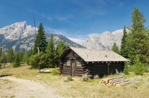 Old log cabin of the wild west in the Yellowstone Ecosystem, western USA, North America. Nearest cities are Jackson, Wyoming, Denver, Colorado and Salt Lake City, Utah.