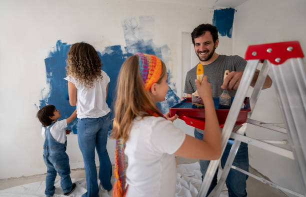 istock Happy family repainting the house 1180089657
