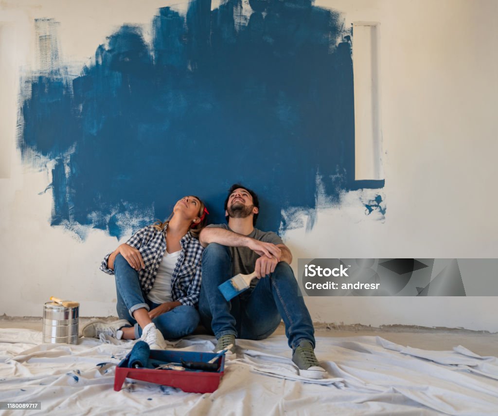 Thoughtful Couple Painting Their House Stock Photo - Download ...