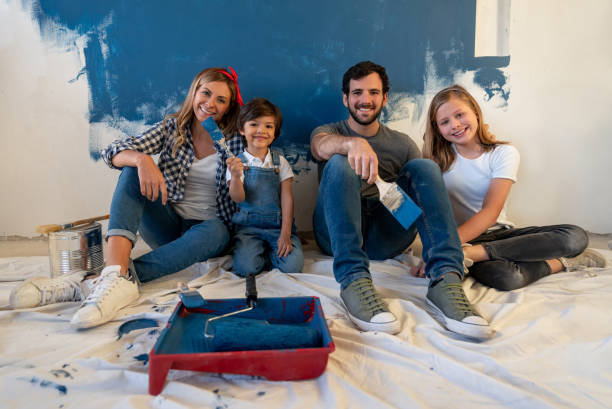 family taking a break from painting their house - home addition home improvement paint decorating imagens e fotografias de stock