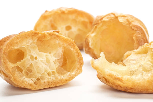 istock Golden baked profiterole isolated on white 1180091360