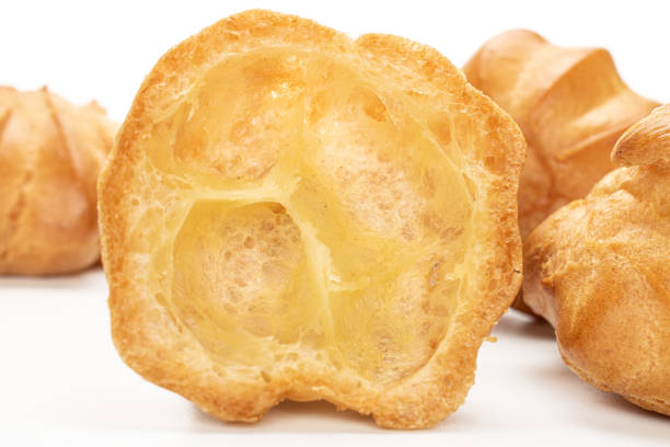 istock Golden baked profiterole isolated on white 1180091463