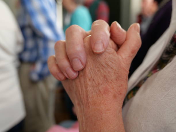 A woman's hands held together in prayer