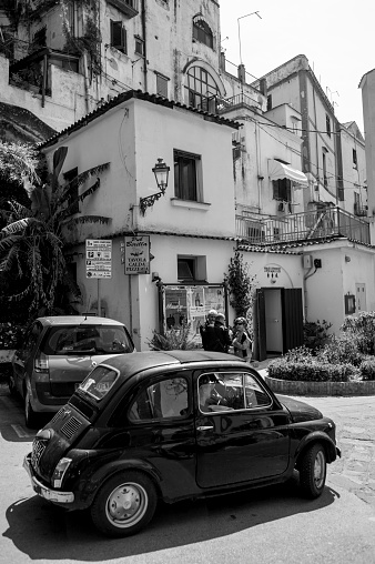 Image taken of an Italian classic bambino car in front of Amalfi Coast living homes in the town of Campania.