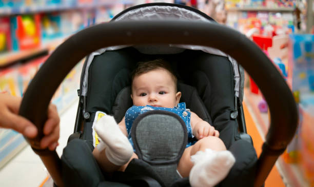 to shop in baby stores with stroller. baby in stroller - department store shopping mall store inside of imagens e fotografias de stock