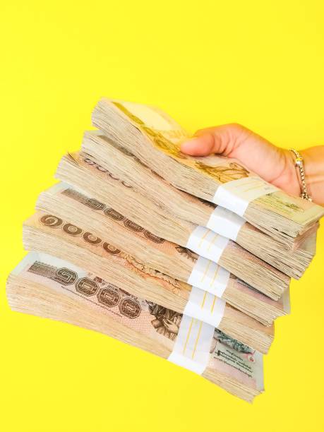 istock Woman hand holding Thai bank note 1180100234