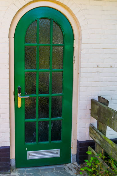 istock Modern green door, building entrance, small window pattern design, architecture background 1180101221