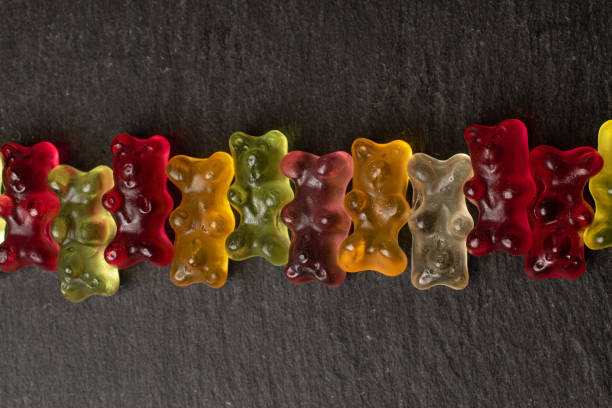istock Colorful gummy bear on grey stone 1180102506