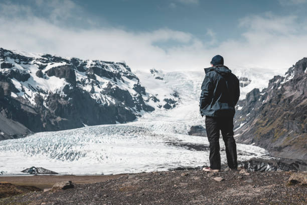 istock The man admires the glacier 1180103500