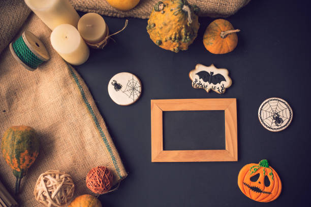 istock Halloween cookies and wooden frame on black background 1180105665