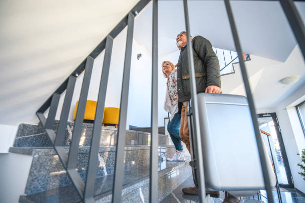 istock Senior Couple Arriving at Vacation Residence 1180105788