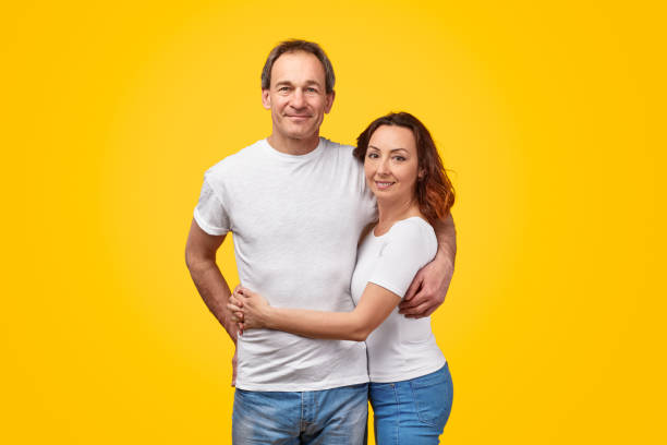 istock Adult couple hugging and looking at camera 1180106576