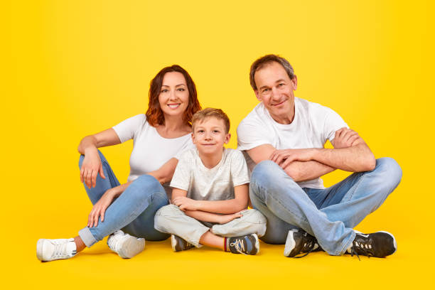 istock Happy family sitting together 1180106578