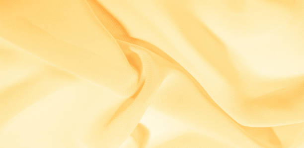 texture background pattern. Yellow silk fabric with a subtle matte sheen. It is perfect for your design, accents, wallpapers, posters and postcards.