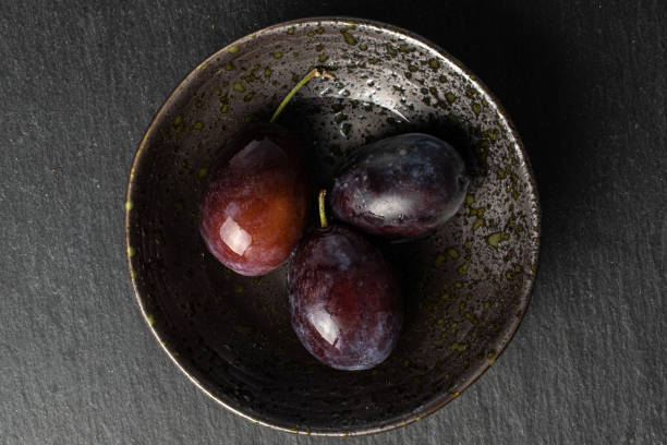 istock Sweet purple plum on grey stone 1180109382